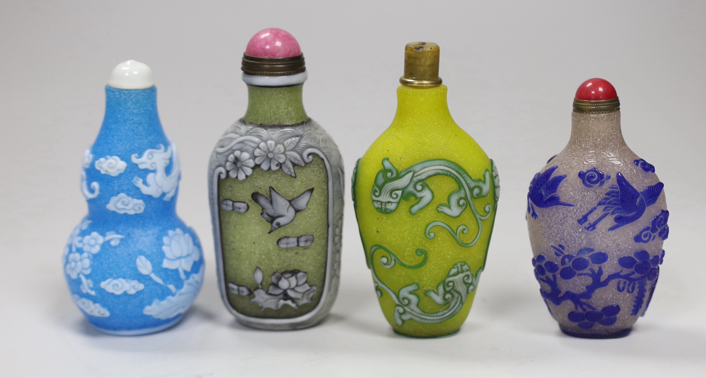 Seven Chinese overlaid glass snuff bottles, tallest 10cm high